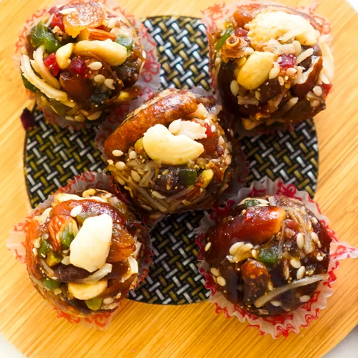 Dry-fruit bites with cashew, sesame and dates in paper cups