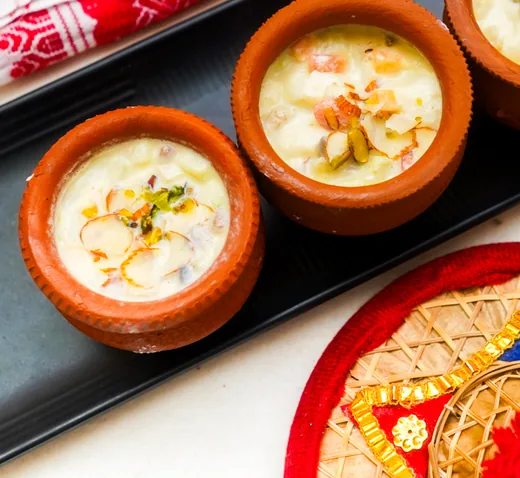 Creamy milk desserts in terracotta kulhads topped with almonds, pistachio and saffron