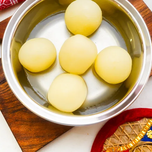 Rasgulla in syrup in a steel bowl