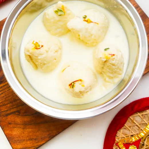 Chenna rounds in creamy milk finished with saffron strands and pistachio